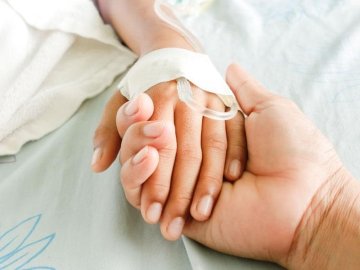adult holding childs hand