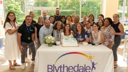 Superintendent Emily Hersh is surrounded by coworkers at her retirement party