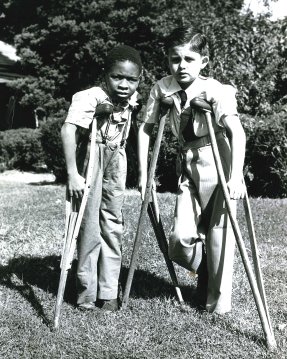 Two boys on crutches outside