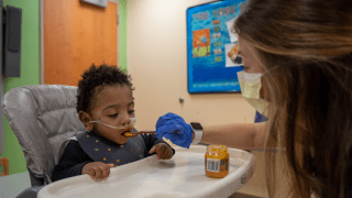baby eating purees from speech therapist