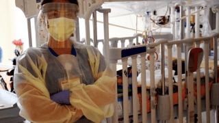 nurse in front of hospital bed