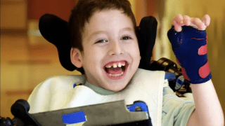 child in wheelchair with brace