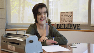 Young woman next to typewriter