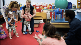 two children walking on therapy mat