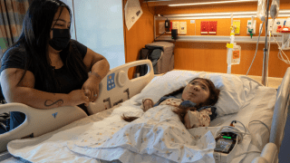 Mom with young daughter in a hospital bed