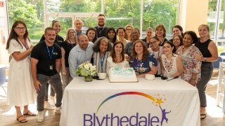 Superintendent Emily Hersh is surrounded by coworkers at her retirement party