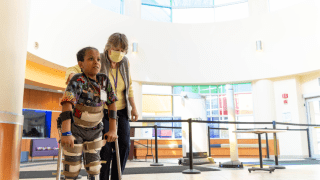 child with braces on walking