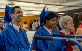 two graduates in classroom