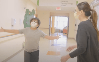 boy and female therapist walking down the hall