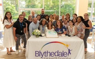Superintendent Emily Hersh is surrounded by coworkers at her retirement party