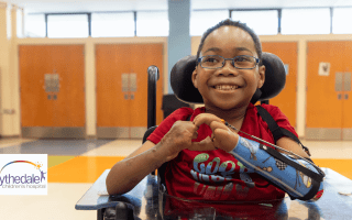 photo of child in a wheelchair with a prosthetic