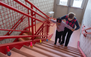 child and therapist walk up staircase