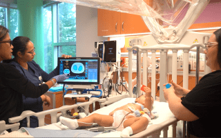 Providers looking at patient and machine