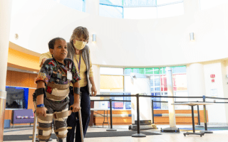 child with braces on walking