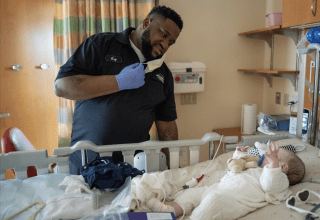 Picture of housekeeping employee looking at baby