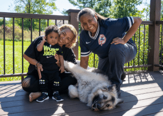 two mothers with baby and dog