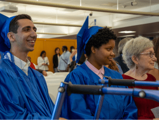 two graduates in classroom