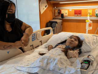 Mom with young daughter in a hospital bed