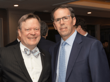 Two men pose for a picture at a gala