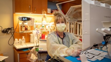 Respiratory Therapist in front of patient bed