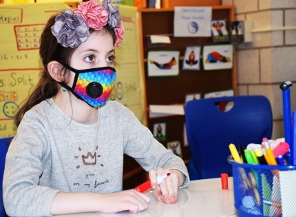 child in school with mask on 