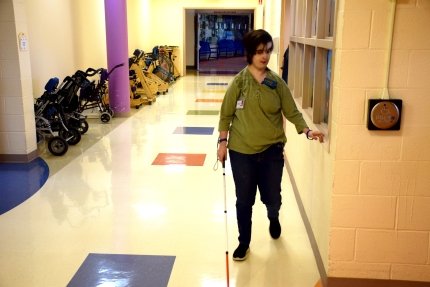 blind woman walking down the hall 