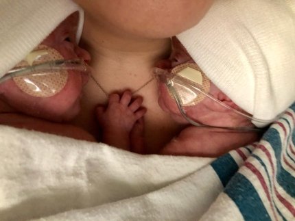 twins on mother's chest