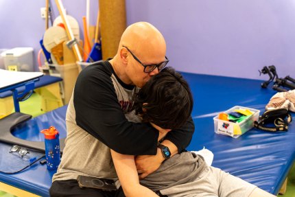 child and father in a hug