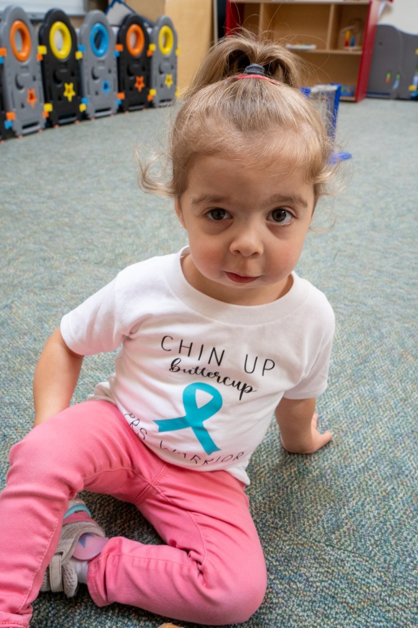 baby in shirt looking at camera